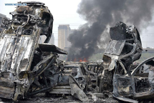 Damaged cars explose and trigger new blasts at the site of explosion in Tianjin, north China, Aug. 15, 2015. (Photo: Xinhua/Jin Liwang)