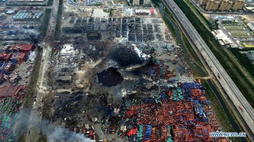 An aerial photo taken on Aug. 14, 2015 shows a huge hole at the core area of explosion site in Tianjin, north China. The death toll from explosions occurred on Wednesday night rises to 85 as of Saturday mornoing. (Photo/Xinhua)