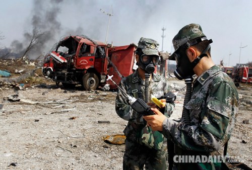 Air quality is monitored amid suspicions that the warehouse stored dangerous chemicals. (Photo by Zhu Xingxin/chinadaily.com.cn)