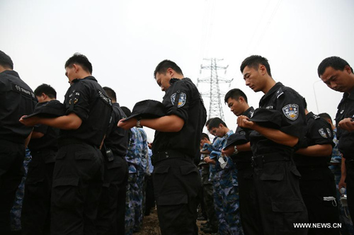 A mourning ceremony is held for the victims of the massive warehouse explosions at the blast site in Tianjin, north China, Aug. 18, 2015. The death toll from last week's massive blasts in Tianjin rose to 114. (Photo: Xinhua/Wang Shen)