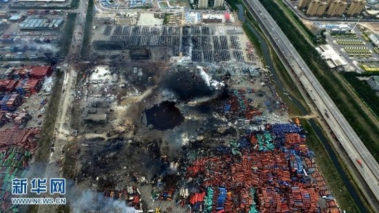 An aerial photograph taken on Aug 16, 2015 shows a huge hole at the center of the site of a series of explosions in North Chinas Tianjin municipality. The hole is filled with dark water.(Photo/Xinhua)