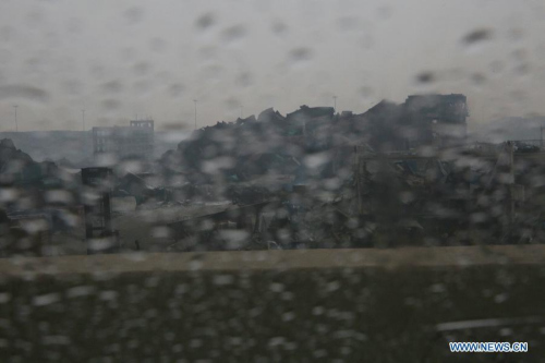 Raindrops are seen on the windscreen of a car near the explosion site in Tianjin, north China, Aug. 18, 2015. A rainfall began to hit the city on Tuesday. (Photo: Xinhua/Wang Shen)