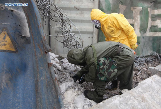 Rescuers carry out cleanup work at the core blast area in Tianjin, north China, Aug. 19, 2015. Cleanup operations of remaining chemicals continued in Tianjin, almost a week after two massive explosions tore through a warehouse storing hazardous goods. (Photo: Xinhua/Wang Haobo)