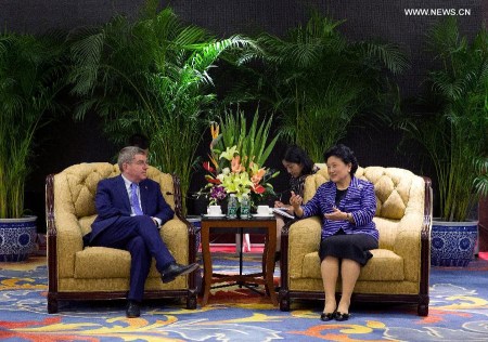 Chinese Vice Premier Liu Yandong (R), also a member of the Political Bureau of the Communist Party of China Central Committee, talks with International Olympic Committee (IOC) President Thomas Bach during a meeting in Beijing, China, Aug. 21, 2015. (Xinhua/Cao Can)