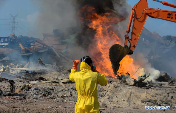 Rescuers clean up the debris at the blast site in Tianjin, north China, Aug. 23, 2015. The death toll from a warehouse blast in Tianjin has risen to 123, including 70 firefighters and seven policemen, authorities said at a press conference on Sunday. All victims' identities have been verified. (Photo: Xinhua/Yin Dongxun) 
