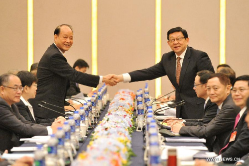 Chinese mainland-based Association for Relations Across the Taiwan Straits (ARATS) president Chen Deming (R) and Taiwan-based Straits Exchange Foundation (SEF) chairman Lin Join-sane shake hands before talks in Fuzhou, capital of southeast China's Fujian Province, Aug. 25, 2015.  (PhotoXinhua/Lin Shanchuan) 