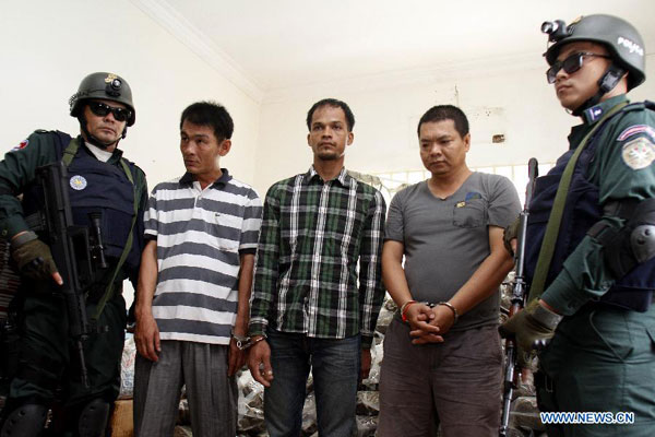Three drug suspects are seen during a press conference in Phnom Penh, Cambodia, Aug. 25, 2015. A senior anti-drug official said here Tuesday the Cambodian police had seized a large amount of marijuana in Phnom Penh and arrested three suspected drug dealers. (Photo/Xinhua)