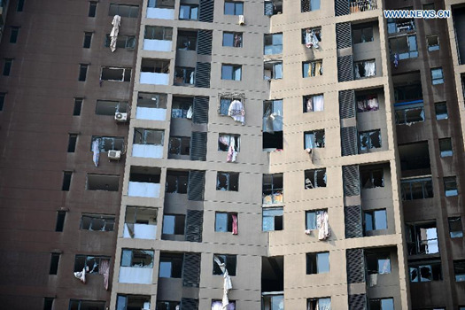 Windows near the site of the explosions are broken at the Binhai new district in north China's Tianjin Municipality, Aug. 13, 2015. (Photo/Xinhua)