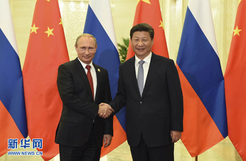 Chinese President Xi Jinping shakes hands with visiting Russian President Vladimir Putin in Beijing, Sept 3, 2015. (Photo/Xinhua)