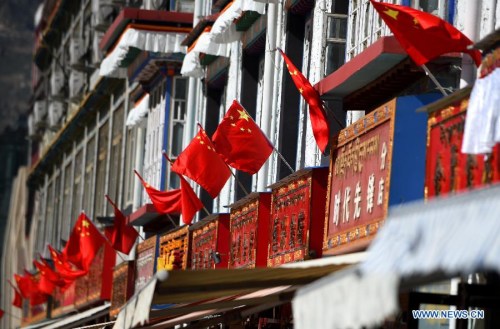 National flags are seen on buildings in Lhasa, capital of southwest China's Tibet Autonomous Region, Sept. 4, 2015. China will hold celebrations for the 50th anniversary of the founding of Tibet Autonomous Region. (Photo: Xinhua/Chogo)