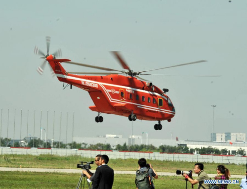 A helicopter practises for the coming China Helicopter Exposition in a helicopter base of Aviation Industry Corporation of China in the Airport Area of China Pilot Free Trade Zone of Tianjin, north China, Sept. 7, 2015. The exposition will be opened on Sept. 9. (Photo: Xinhua/Wang Huan)