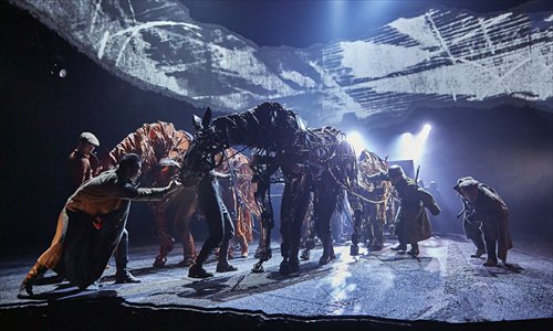 Puppet horses Joey (left) and Topthorn pull military vehicles driven by German soldiers in a scene from stage play War Horse. Photo: Courtesy of the Chinese production of War Horse
