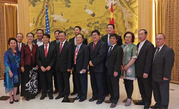 Chinese Consul General Li Qiangmin (front row, fourth from left) takes a photo with Chinese community leaders who were invited to observe the military parade in Beijing on Sept 13. PROVIDED TO CHINA DAILY