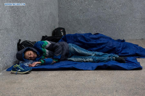 Refugees rest at a railway station in Salzburg, Austria, on Sept. 14. 2015. German Interior Minister Thomas de Maiziere on Sunday announced that Germany temporarily reinstates border control amid the ongoing refugee crisis. According to German newspaper Passauer Neue Presse, the German government also stopped the trains to and from Austria. (Photo: Xinhua/Qian Yi)