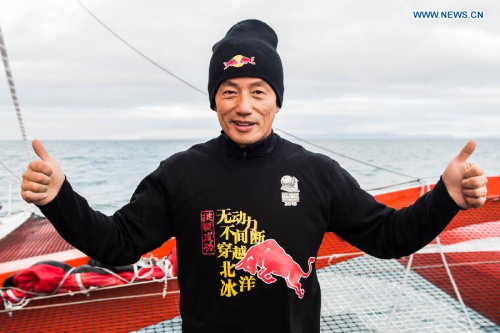 Chinese skipper Guo Chuan poses for photo after finally crossing the finish line on the Bering Strait at 16.48 UTC on September 15. (Photo/Xinhua)