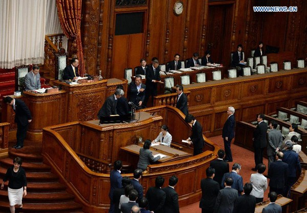 Japan's lawmakers line up to cast their ballots during a plenary session for a vote on security laws at the upper house of the parliament in Tokyo, Japan, on Sept. 19, 2015. Japan abandoned its 70-year pacifism since the end of World War II as the parliament's upper house on early Saturday enacted a controversial legislation pushed forward by the government under Prime Minister Shinzo Abe. (Xinhua/Ma Ping)
