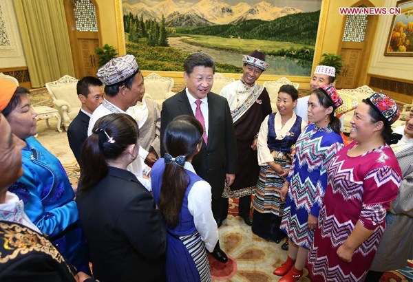 Chinese President Xi Jinping (C) meets with 13 outstanding grass-roots ethnic solidarity representatives at the Great Hall of the People in Beijing, capital of China, Sept. 30, 2015. On the 66th anniversary of the founding of the People's Republic of China, President Xi Jinping invited the 13 outstanding grass-roots ethnic solidarity representatives, who are from the five autonomous regions of Inner Mongolia, Guangxi, Tibet, Ningxia and Xinjiang, to Beijing to attend the national day celebrations. (Xinhua/Yao Dawei)