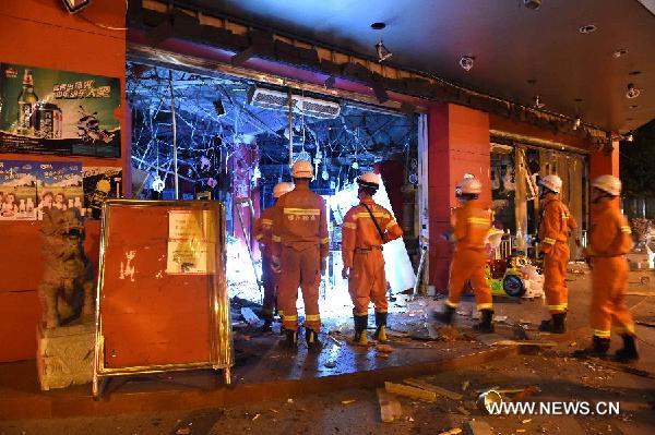 Firemen enter a blast site in Liucheng County, south China's Guangxi Zhuang Autonomous Region, on Sept. 30, 2015. The death toll from 17 suspected letter bombs in Liucheng on Wednesday afternoon has risen to seven, with two missing and another 51 injured. The explosions occurred at the seat of Liucheng county and the surrounding areas, including a shopping mall and the dorm of a local animal husbandry bureau, with the first heard at about 3:15 p.m.. Police have identified a 33-year-old man named Wei, a native of Liucheng county, as a suspect. (Xinhua/Zhang Ailin)