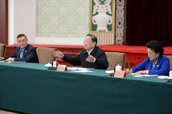 Yu Zhengsheng (C), chairman of the National Committee of the Chinese People's Political Consultative Conference (CPPCC), speaks while hearing a work report by Xinjiang Party and government, in Urumqi, northwest China's Xinjiang Uygur Autonomous Region, Sept. 30, 2015. (Xinhua/Zhang Ling)