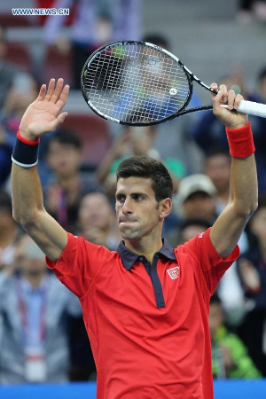 Novak Djokovic of Serbia celebrates his victory over Zhang Ze of China during the men's singles second round match at the China Open tennis tournament in Beijing, China, Oct. 8, 2015. Djokovic was qualified for the next round after beating Zhang 2-0. (Photo: Xinhua/Xing Guangli)
