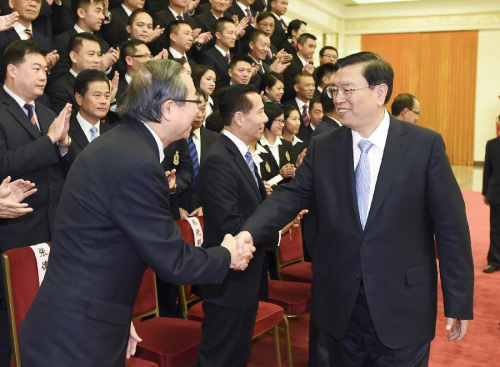 Zhang Dejiang (R, front), chairman of China's National People's Congress (NPC) Standing Committee, meets with a delegation of security units of the Hong Kong Special Administrative Region (HKSAR), in Beijing, capital of China, Oct. 9, 2015. (Xinhua/Xie Huanchi)