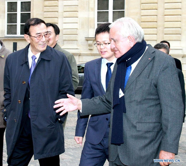 Qiangba Puncog (L, front), vice chairman of the Standing Committee of China's National People's Congress (NPC), talks with Jean-Pierre Raffarin (R, front), chairman of French Senate's commission on foreign affairs, in Paris, France, Oct. 14, 2015. Qiangba Puncog paid a friendship visit to France from Oct. 11 to Oct. 14. (Xinhua/Zheng Bin)