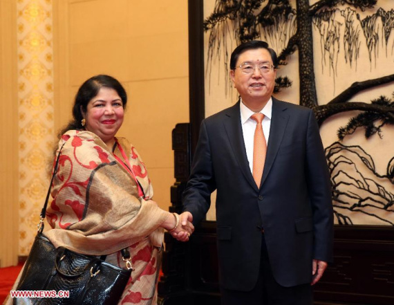 Zhang Dejiang, chairman of the Standing Committee of the National People's Congress, shakes hands with Speaker of the Bangladesh National Assembly Shirin Sharmin Chowdhury at the Great Hall of the People in Beijing, China, Oct. 15, 2015. (Photo: Xinhua/Liu Weibing)