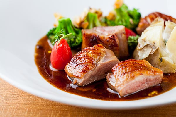 Duck breast roasted with honey, served with baked potato, broccoli and almond slice. (Photo provided to China Daily)