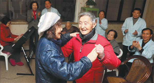 A couple dances in the entertainment room at a nursing home in Shanghai's Hongkou district. Converted from a seven-story hotel, the nursing home can accommodate about 300 people. Pei Xin / Xinhua