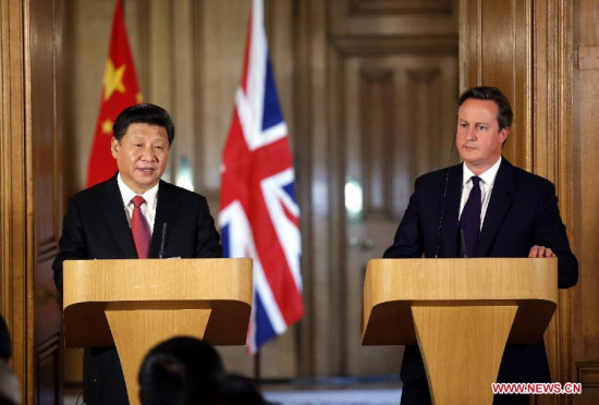 Chinese President Xi Jinping (L) and British Prime Minister David Cameron meet media after their talks at 10 Downing Street in London, Britain, Oct. 21, 2015. (Photo: Xinhua/Ju Peng)