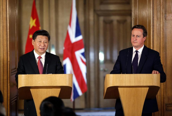 Chinese President Xi Jinping (L) and British Prime Minister David Cameron meet media after their talks at 10 Downing Street in London, Britain, Oct. 21, 2015. (Photo: Xinhua/Ju Peng)