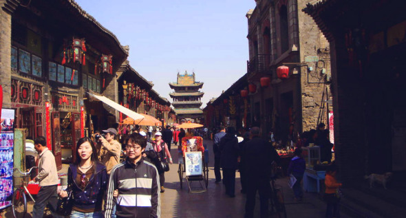 Pingyao's South Street has become the main thoroughfare for tourists, but it still maintains a lot of charm. The central tower stands in the background. Photo: CRIENGLISH.COM/William Wang