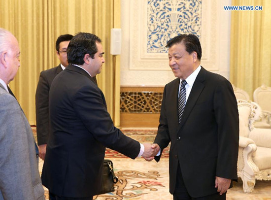Liu Yunshan (R), a member of the Standing Committee of the Political Bureau of the Communist Party of China (CPC) Central Committee, meets with a visiting delegation of cadres of Chile's ruling coalition, in Beijing, capital of China, Oct. 30, 2015. (Xinhua/Pang Xinglei)