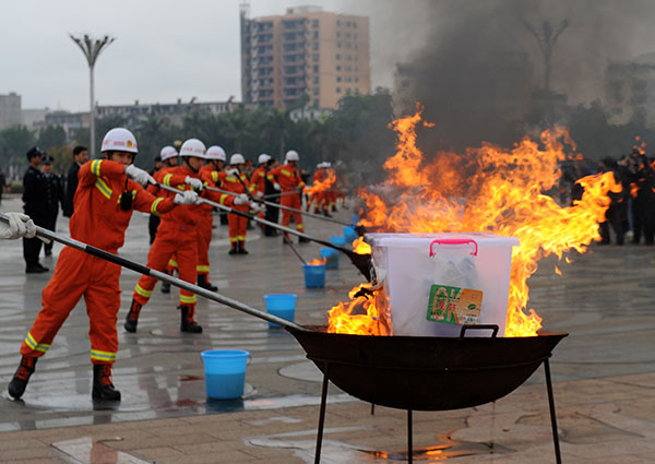 Drugs from China and Vietnam are destroyed in Ningming, Guangxi, on March 10 last year. LI BIN / XINHUA