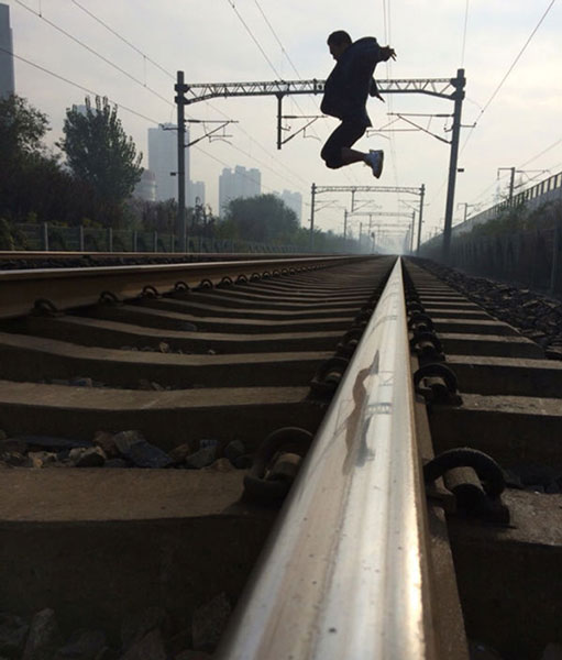 A man jumps on a train track. (Photo provided by the police)