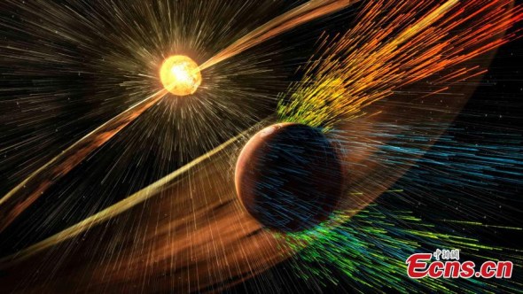 An undated artist's rendering depicts a solar storm hitting Mars and stripping ions from the planet's upper atmosphere in this NASA handout released Thursday. Scientists have documented a solar storm blasting away Mars' atmosphere, an important clue in a long-standing mystery of how a planet that was once like Earth turned into a cold, dry desert. (Photo/Agencies)