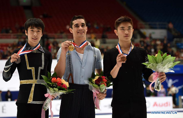 Gold medalist Javier Fernandez (C) of Spain, silver medalist Jin Boyang (L) of China and bronze medalist Yan Han of China pose during the awarding ceremony of the men's category at the 2015 Audi Cup ISU Grand Prix of Figure Skating in Beijing, capital of China, on Nov. 7, 2015. (Xinhua/Guo Yong)