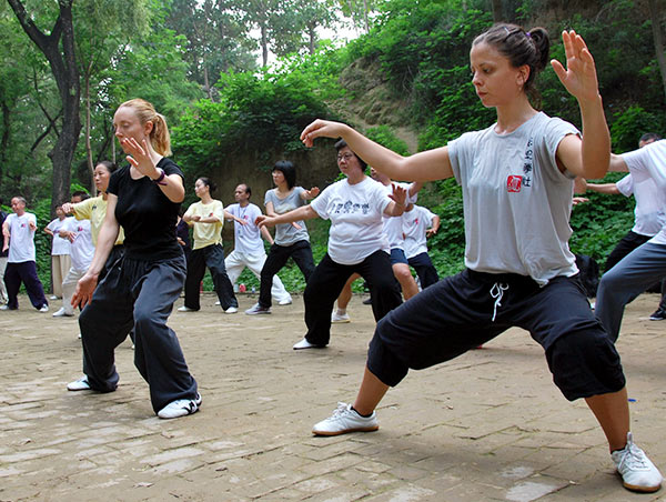 Students practice tai chi at a martial arts school in Chenjiagou, Wenxian county, Henan province, on Nov 1. Xu Hongxing / for China Daily