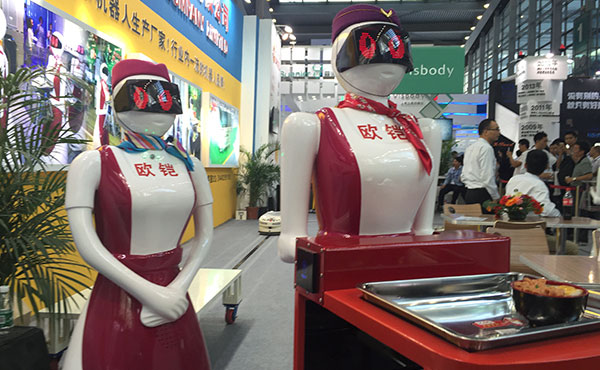 Smart waitresses, developed by Shenzhen Okagv Company Limited, are seen at the China Hi-tech Fair, which opens in Shenzhen, Guangdong province, on November 16, 2015. (Photo by Qiu Quanlin/China Daily)