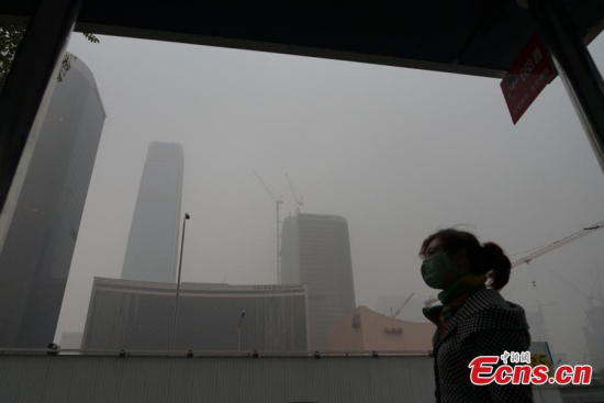 Photo taken in CBD of Beijing, China, Nov. 13, 2015. Beijing government issued a yellow signal warning against heavy pollution as smog cloaked the city on Friday. (CNS photo/ Xiongran)