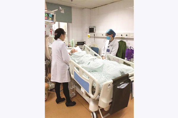 Doctors stand beside Yan Baozhen at Nanjing Hospital of T.C.M. in Nanjing, capital city of East Chinas Jiangsu province. on Nov 18, 2015. (Photo/xhby.net)