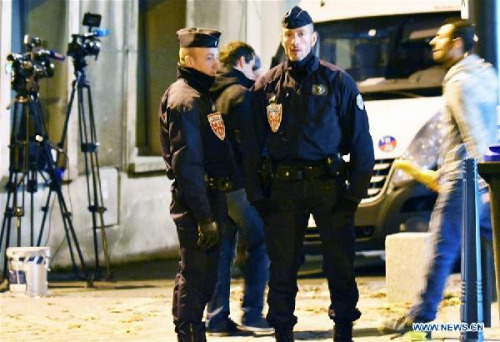 Policemen stands guard at a crossing in Saint-Denis, France, on Nov. 18. (Xinhua/Li Genxing)