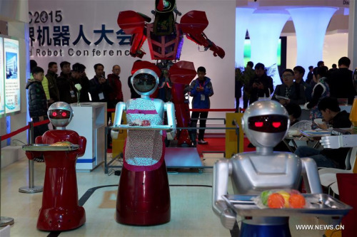 Robots that can serve as waiters are demonstrated during the World Robot Conference in Beijing, capital of China, Nov. 23, 2015. (Xinhua/Jin Liwang)