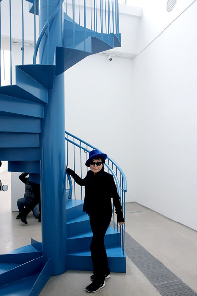 Yoko Ono poses with her work, To See the Sky, at her solo show in Beijing. (Photo:China Daily/Jiang Dong)