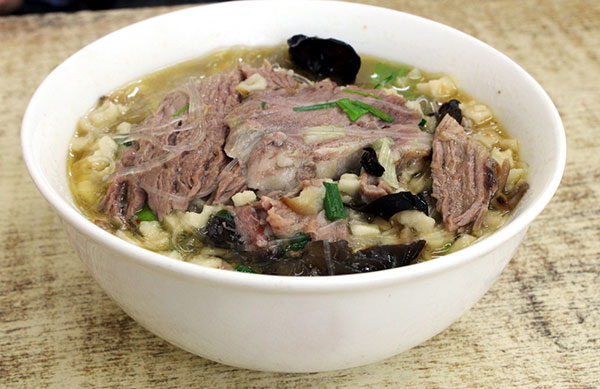 Pita bread in mutton soup is among Xi'an's delicacies. CHINA DAILY