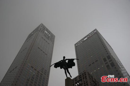 Photo taken in CBD of Beijing, China, Nov. 13, 2015. Beijing government issued a yellow signal warning against heavy pollution as smog cloaked the city on Friday. (CNS photo/ Xiongran)