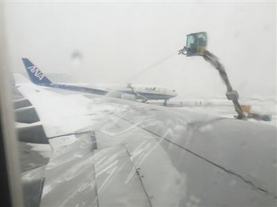 A plane is de-iced at the airport. (Photo/the Beijing Youth Daily)