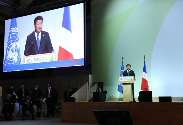 President Xi Jinping is seen on a giant screen as he delivers a speech for the opening day of the World Climate Change Conference 2015 (COP21) at Le Bourget, near Paris, France, November 30, 2015.(Photo/Xinhua)