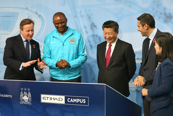 President Xi Jinping is joined by British Prime Minister David Cameron, former Manchester City star Patrick Vieira (second from left) and Manchester City Chairman Khaldoon Al Mubarak (second from right) at the City Football Academy in Manchester, England, on Oct 23. WU ZHIYI / CHINA DAILY
