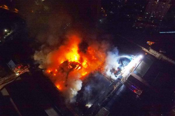 Photo taken on Dec. 2, 2015 shows the fire site of a warehouse in Yangpu District of Shanghai, east China. The fire has been put out. No casualties were reported. (Photo: Xinhua/Shen Chunchen)